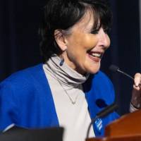 President Mantella standing at podium, smiling at audience